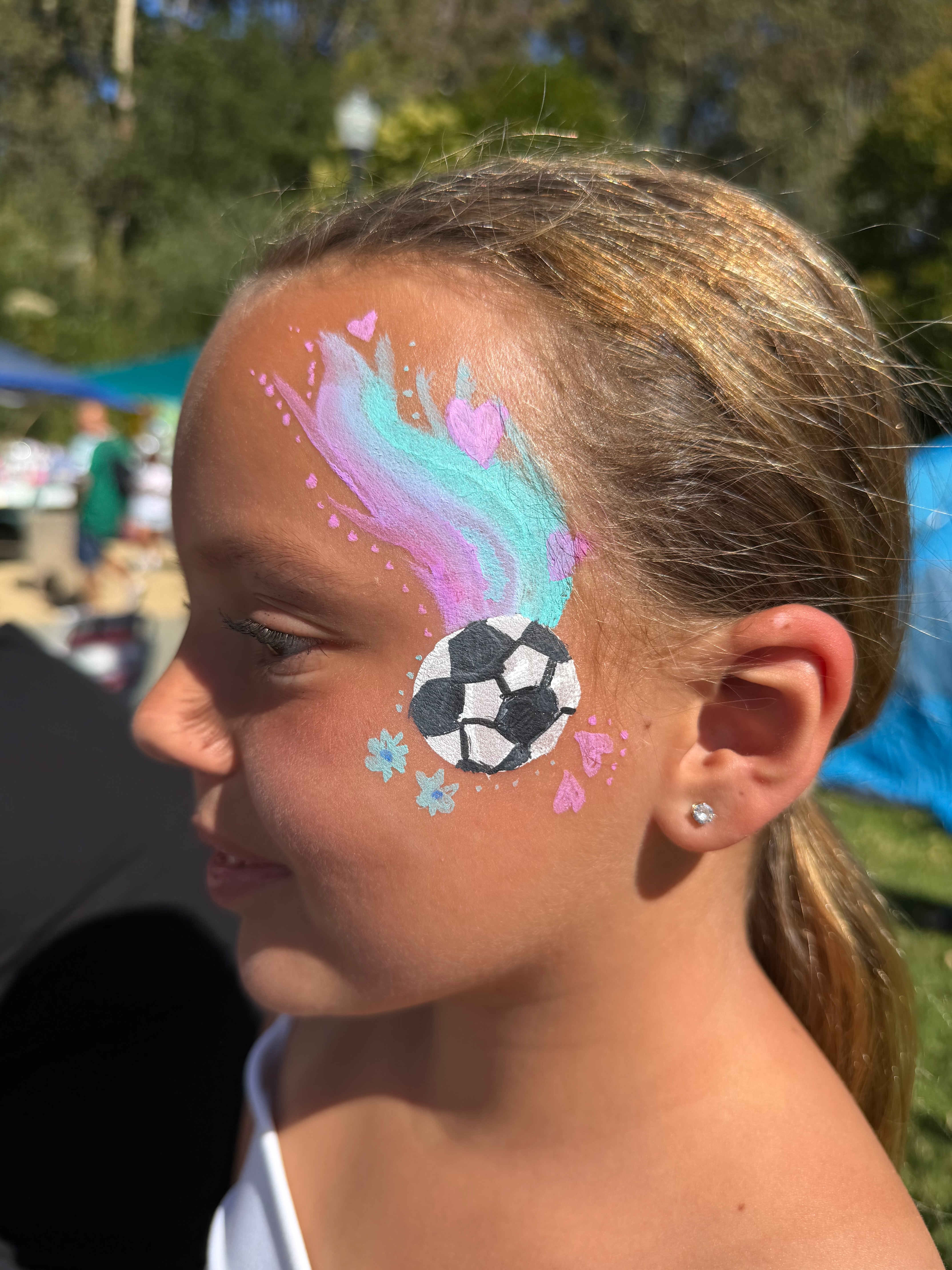Soccer ball with pastel pink and teal swirls face painting